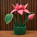Handcrafted coir lotus flower pot made from natural coconut fibre with green leaves and pink lotus petals.