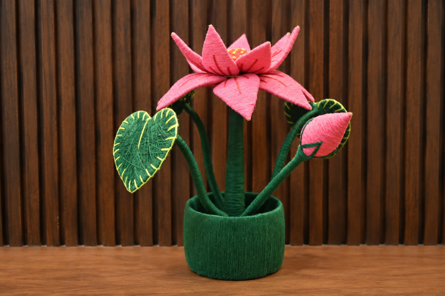 Handcrafted coir lotus flower pot made from natural coconut fibre with green leaves and pink lotus petals.