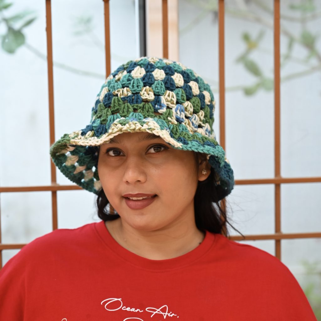 Ocean Breeze crochet bucket hat made from acrylic yarn in teal, blue, green, and cream shades
