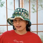 Ocean Breeze crochet bucket hat made from acrylic yarn in teal, blue, green, and cream shades