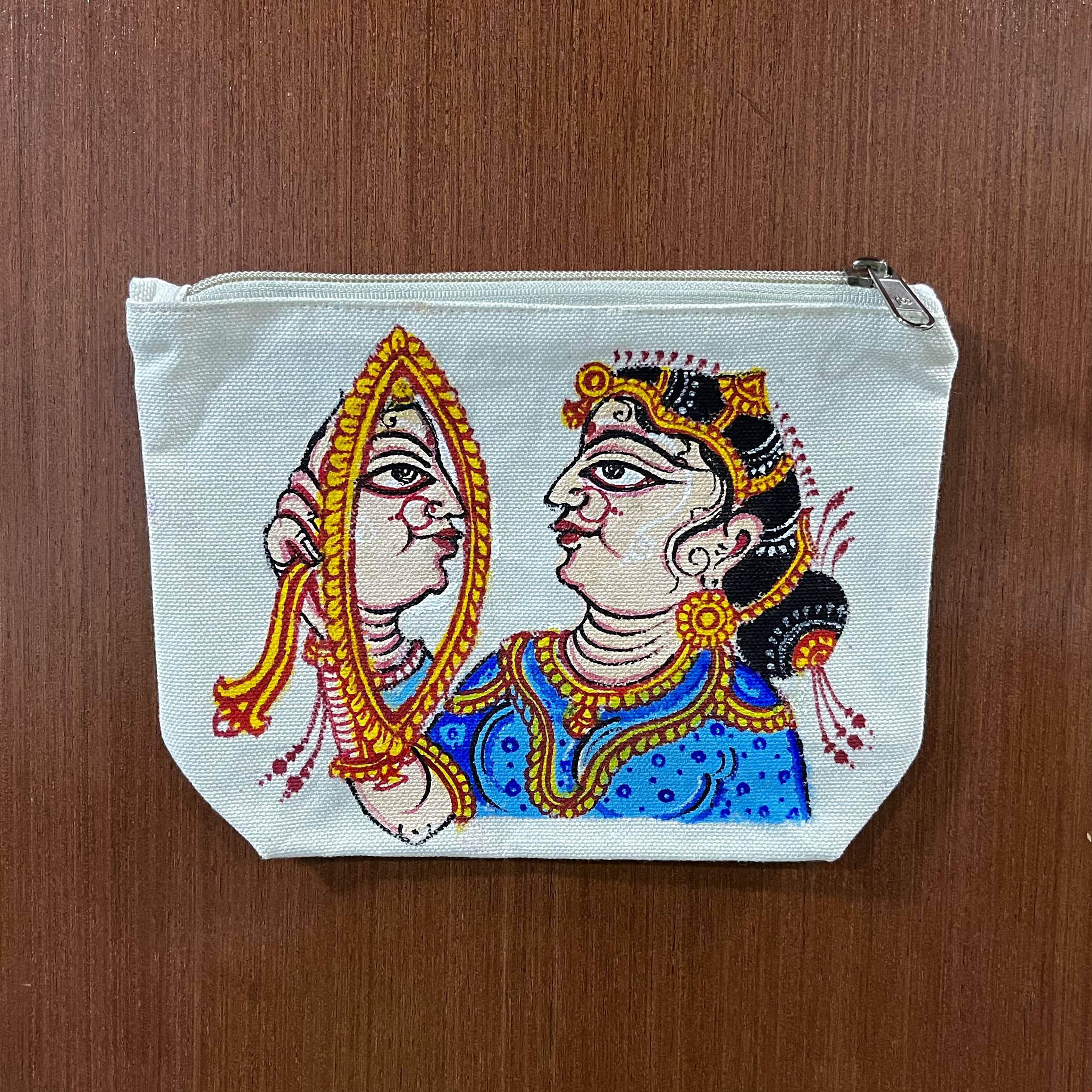 Hand-painted Pattachitra canvas zipper pouch featuring a traditional woman holding a mirror on premium cotton canvas.