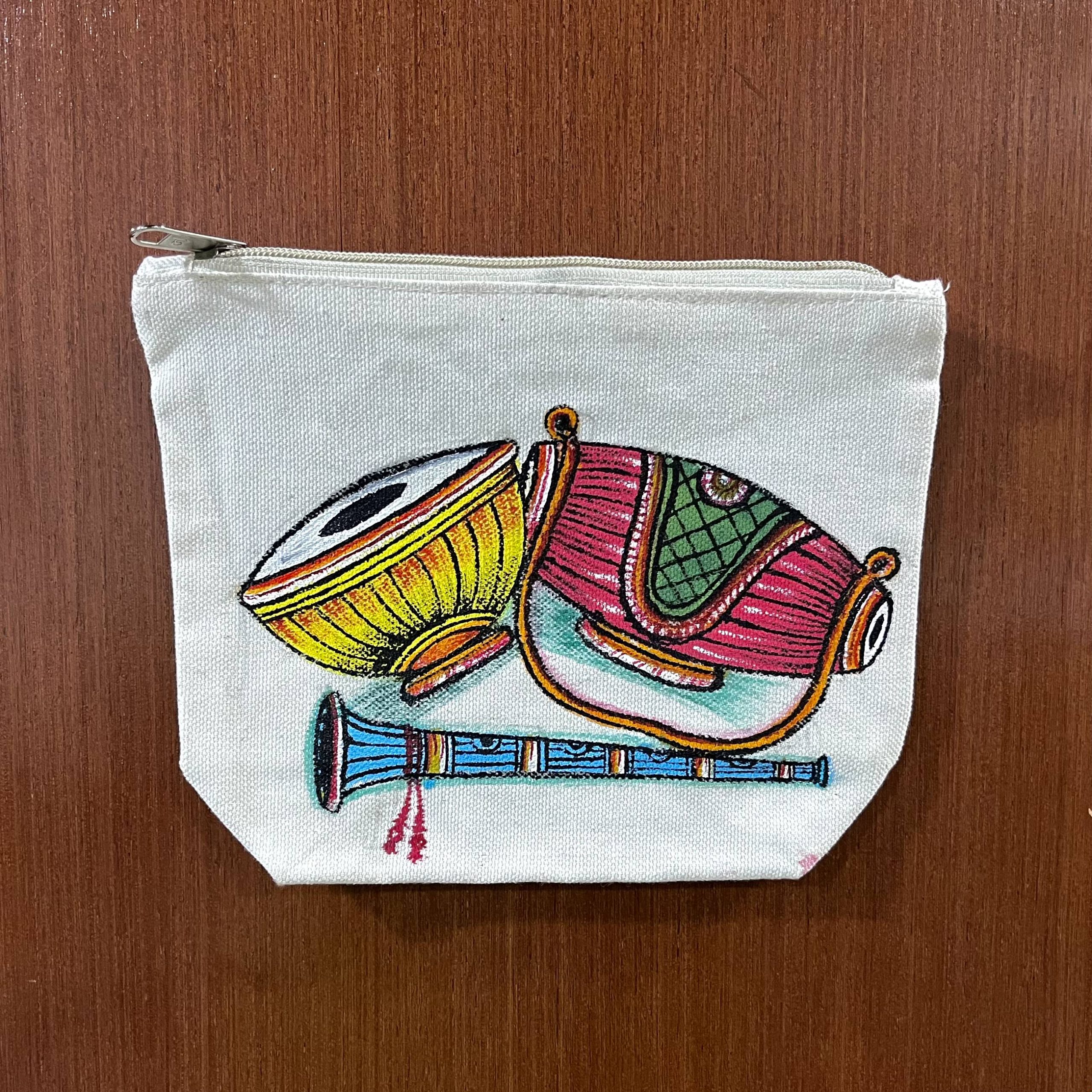 Hand-painted Pattachitra canvas pouch featuring traditional Odisha musical instruments on premium cotton canvas.
