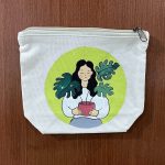 Hand-Painted Botanical Girl Canvas Pouch featuring a girl holding a potted plant surrounded by lush green leaves